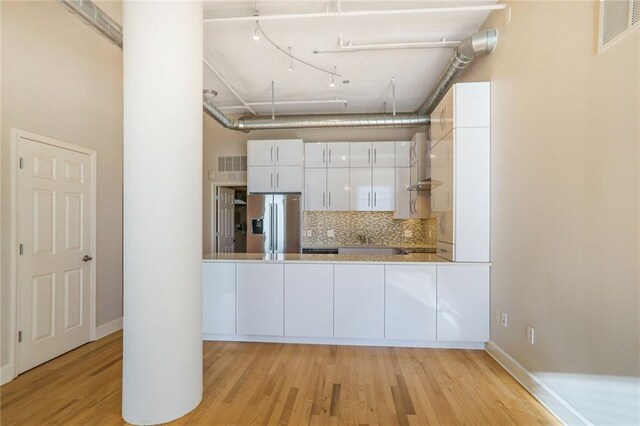 3820 Roswell Rd NE Unit 317, Atlanta, GA 30342 - unfurnished dining area with plenty of natural light, baseboards, and light wood finished floors