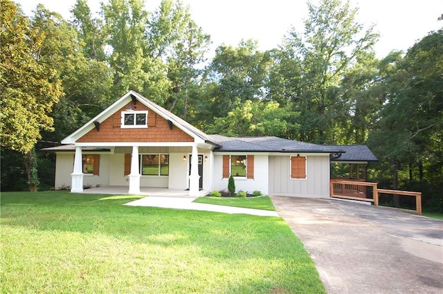 view of front of home with a front yard and a porch