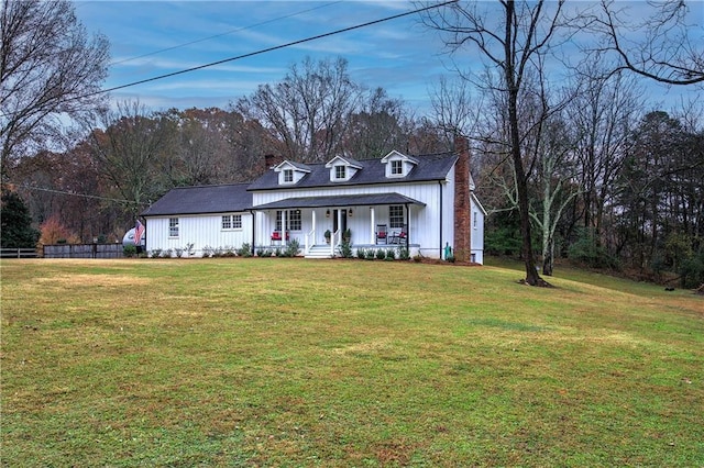 cape cod house featuring a front yard and a porch