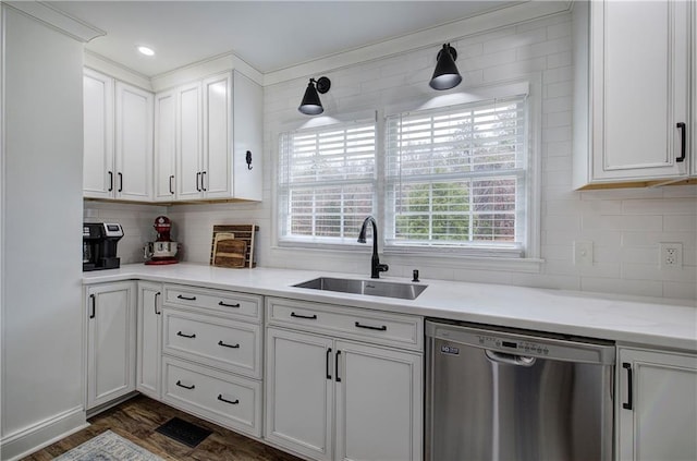 kitchen with white cabinets, sink, stainless steel dishwasher, dark hardwood / wood-style floors, and decorative backsplash