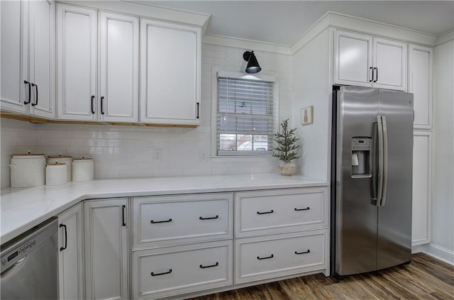 kitchen with backsplash, dark wood-type flooring, white cabinets, and stainless steel appliances