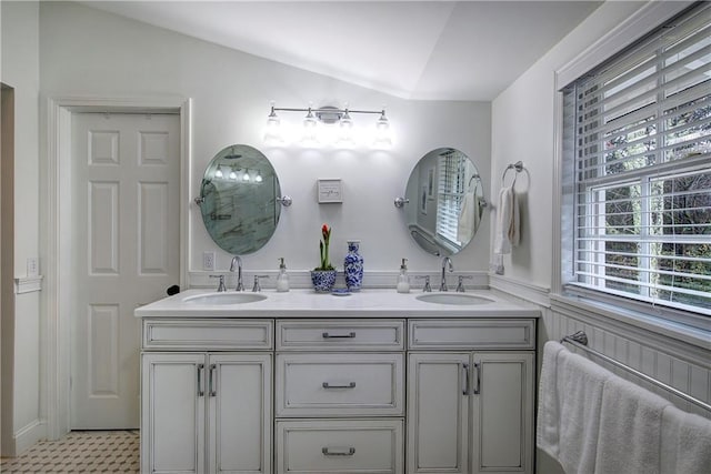 bathroom with vanity, plenty of natural light, and lofted ceiling