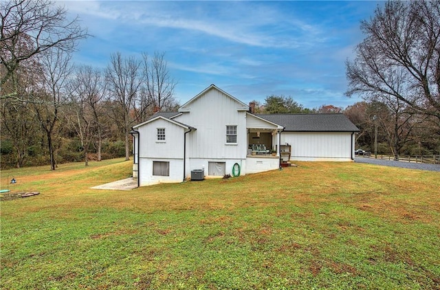 exterior space with a yard and central AC