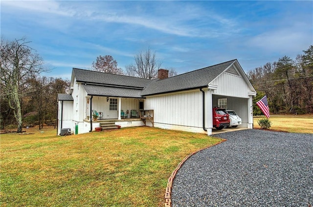 view of front of home featuring covered porch, a front lawn, and a carport