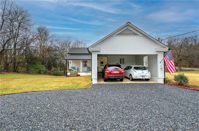 view of front of home featuring a front yard, a carport, and covered porch