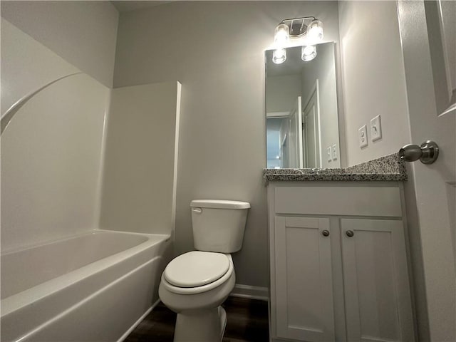 full bathroom featuring bathing tub / shower combination, vanity, and toilet