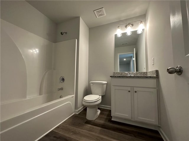 full bathroom with bathing tub / shower combination, hardwood / wood-style floors, vanity, and toilet