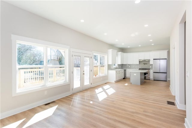 3286 Bachelor St, East Point, GA 30344 - kitchen with stainless steel appliances, healthy amount of natural light, white cabinets, light countertops, and recessed lighting