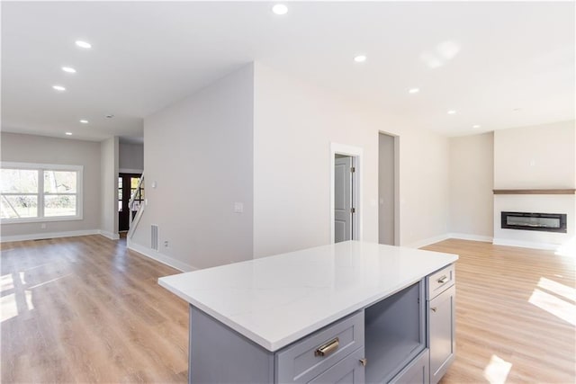 3286 Bachelor St, East Point, GA 30344 - kitchen featuring open floor plan, gray cabinetry, a kitchen island, light wood-style floors, and recessed lighting