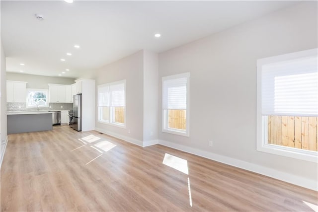 3286 Bachelor St, East Point, GA 30344 - unfurnished living room with light wood-style flooring and recessed lighting