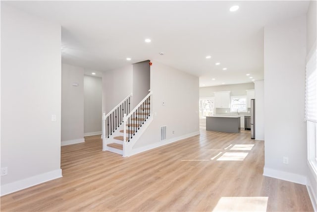 3286 Bachelor St, East Point, GA 30344 - unfurnished living room featuring stairs, light wood finished floors, and recessed lighting