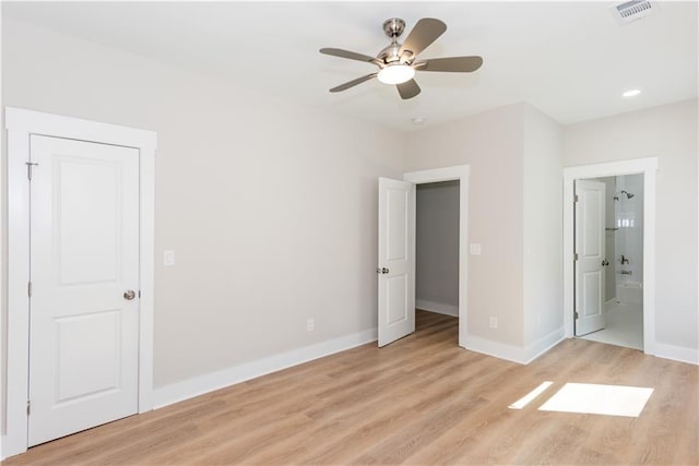 3286 Bachelor St, East Point, GA 30344 - unfurnished bedroom featuring light wood-style floors, connected bathroom, and a ceiling fan