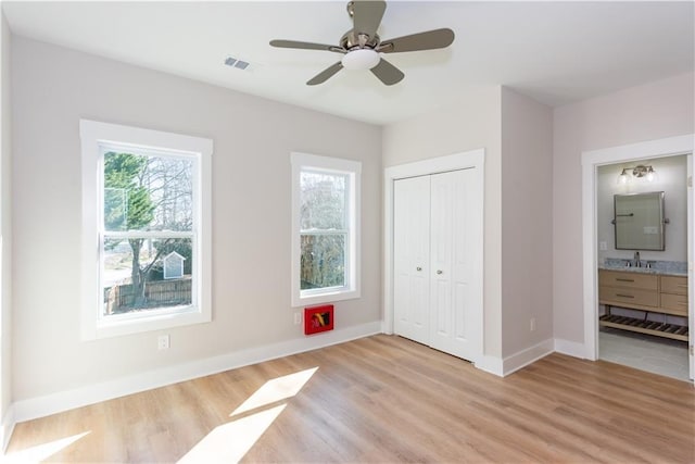 3286 Bachelor St, East Point, GA 30344 - unfurnished bedroom with light wood-style flooring, a closet, ensuite bathroom, and a ceiling fan