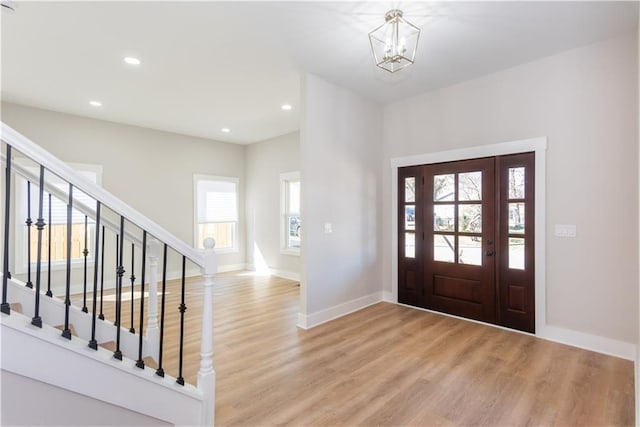 3286 Bachelor St, East Point, GA 30344 - foyer entrance featuring light wood finished floors, a chandelier, stairs, and recessed lighting
