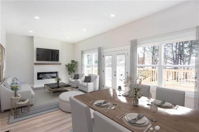 3286 Bachelor St, East Point, GA 30344 - dining area featuring light wood-style floors, a glass covered fireplace, recessed lighting, and french doors