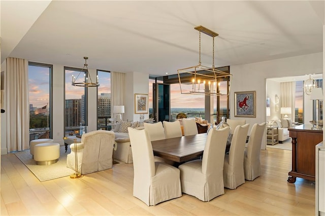 3107 Peachtree Rd NE Unit 1403, Atlanta, GA 30305 - dining space featuring expansive windows, light wood-style floors, an inviting chandelier, and a healthy amount of sunlight