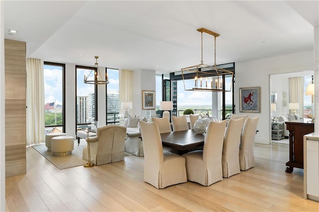 3107 Peachtree Rd NE Unit 1403, Atlanta, GA 30305 - dining space with light wood finished floors, a notable chandelier, and expansive windows