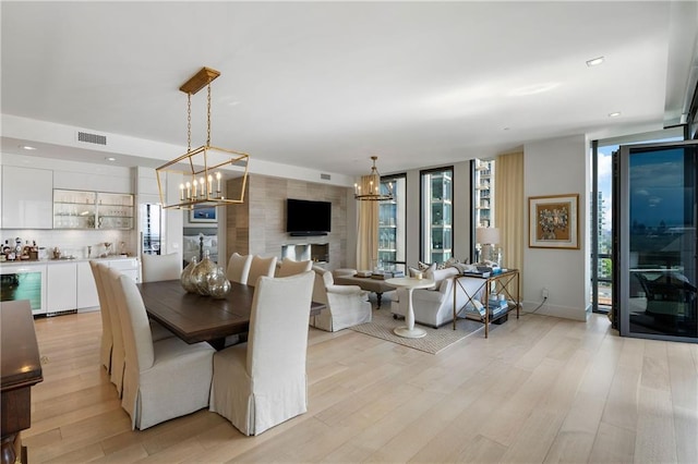 3107 Peachtree Rd NE Unit 1403, Atlanta, GA 30305 - dining space with wine cooler, a wealth of natural light, light wood-type flooring, and a notable chandelier