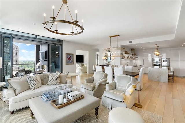 3107 Peachtree Rd NE Unit 1403, Atlanta, GA 30305 - living area with light wood-style floors, a notable chandelier, and visible vents