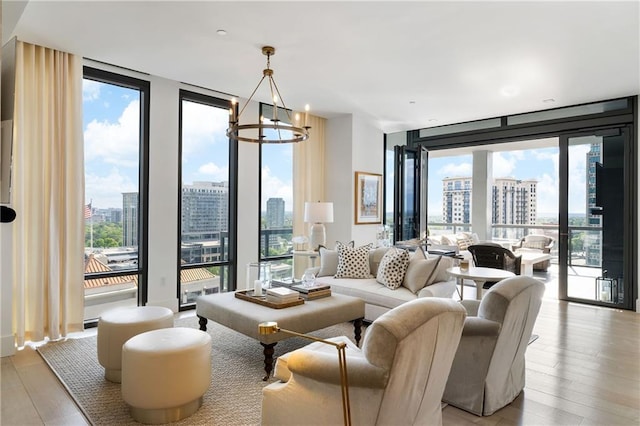 3107 Peachtree Rd NE Unit 1403, Atlanta, GA 30305 - living room featuring expansive windows, light wood-type flooring, a city view, and an inviting chandelier