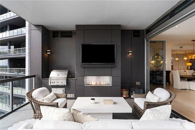 3107 Peachtree Rd NE Unit 1403, Atlanta, GA 30305 - living area with a chandelier, wood finished floors, and a fireplace