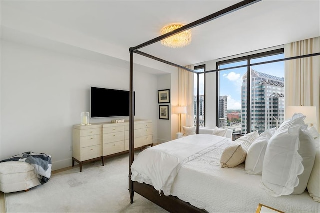 3107 Peachtree Rd NE Unit 1403, Atlanta, GA 30305 - bedroom with baseboards, a wall of windows, and carpet floors