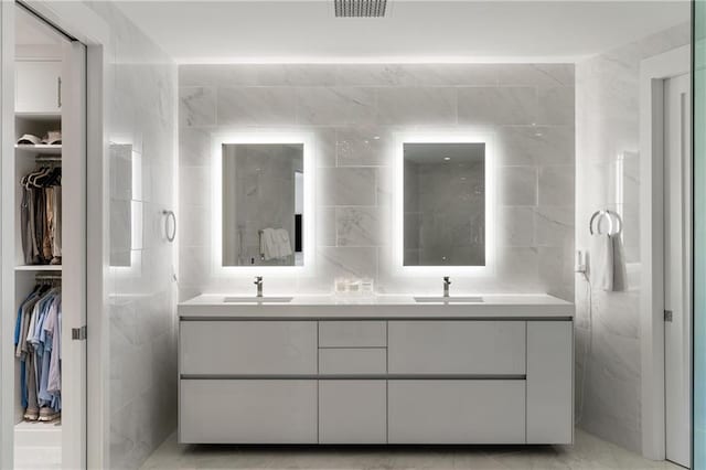 3107 Peachtree Rd NE Unit 1403, Atlanta, GA 30305 - full bath featuring a sink, a spacious closet, tile walls, and double vanity