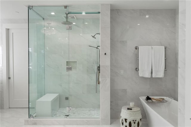 3107 Peachtree Rd NE Unit 1403, Atlanta, GA 30305 - full bathroom with visible vents, tile walls, a soaking tub, and a stall shower