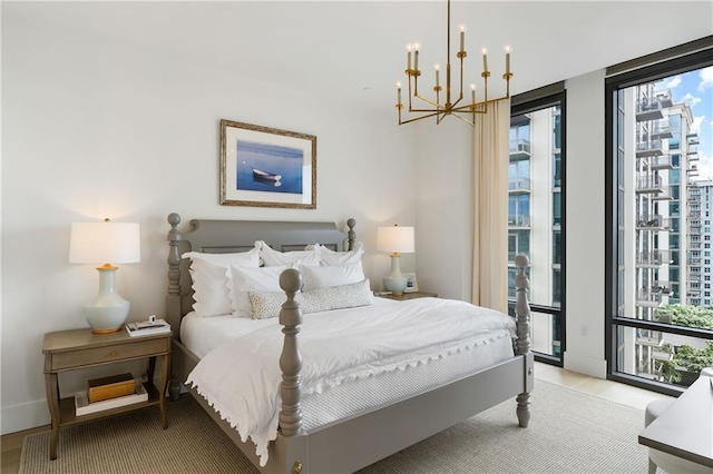 3107 Peachtree Rd NE Unit 1403, Atlanta, GA 30305 - bedroom with access to outside, multiple windows, an inviting chandelier, and wood finished floors