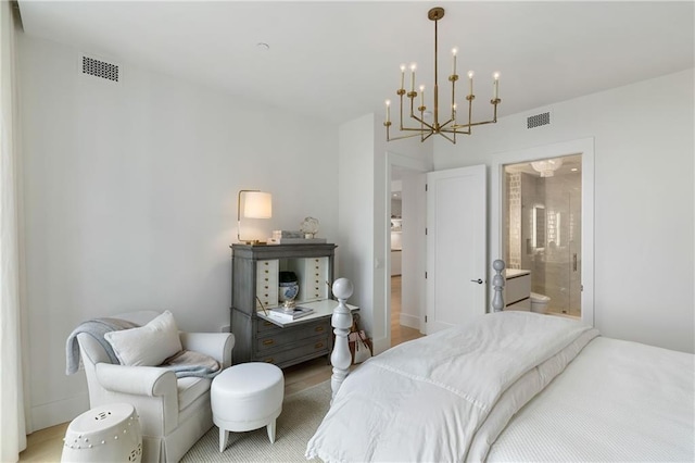 3107 Peachtree Rd NE Unit 1403, Atlanta, GA 30305 - bedroom with a chandelier, wood finished floors, ensuite bathroom, and visible vents