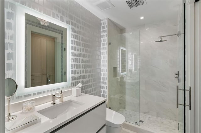 3107 Peachtree Rd NE Unit 1403, Atlanta, GA 30305 - bathroom with a shower stall, vanity, visible vents, and toilet