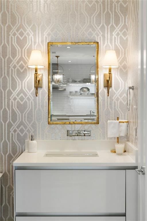 3107 Peachtree Rd NE Unit 1403, Atlanta, GA 30305 - bathroom featuring wallpapered walls and vanity