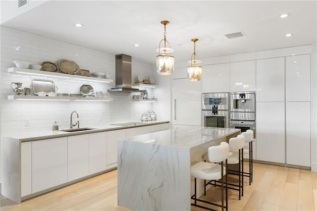 3107 Peachtree Rd NE Unit 1403, Atlanta, GA 30305 - kitchen featuring open shelves, stainless steel double oven, wall chimney exhaust hood, modern cabinets, and a sink