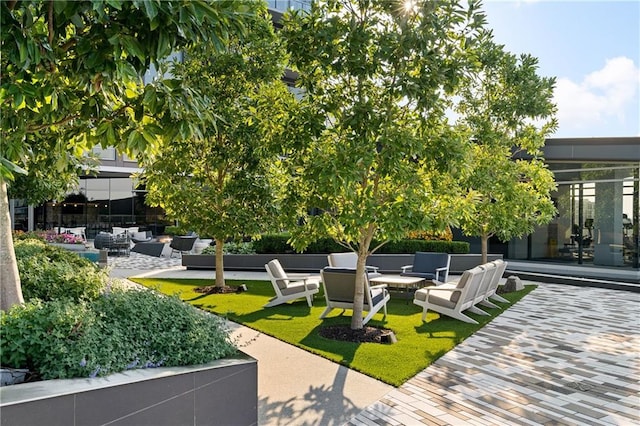 3107 Peachtree Rd NE Unit 1403, Atlanta, GA 30305 - view of community with a patio area and an outdoor living space with a fire pit