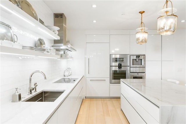3107 Peachtree Rd NE Unit 1403, Atlanta, GA 30305 - kitchen with modern cabinets, double oven, a sink, island range hood, and black electric cooktop
