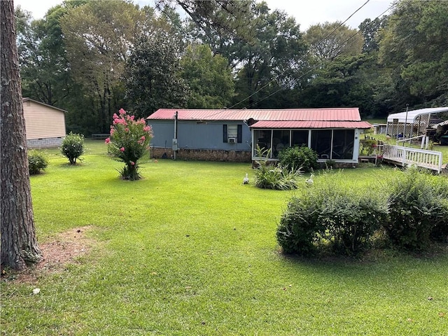 view of yard with a deck and a sunroom