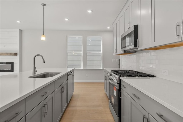 714 Smokey Quartz Way, Kennesaw, GA 30144 - kitchen with appliances with stainless steel finishes, a sink, gray cabinets, decorative backsplash, and recessed lighting