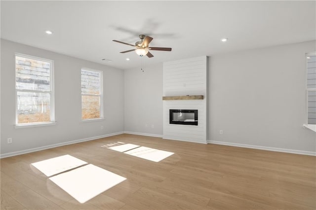 714 Smokey Quartz Way, Kennesaw, GA 30144 - unfurnished living room featuring light wood-type flooring, ceiling fan, a fireplace, baseboards, and recessed lighting