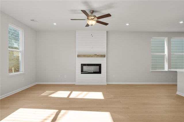 714 Smokey Quartz Way, Kennesaw, GA 30144 - unfurnished living room with light wood-style flooring, ceiling fan, baseboards, a fireplace, and recessed lighting
