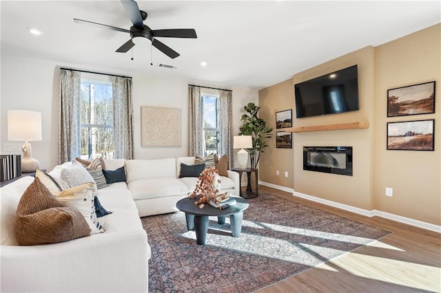 714 Smokey Quartz Way, Kennesaw, GA 30144 - living area with wood finished floors, a glass covered fireplace, ceiling fan, baseboards, and recessed lighting