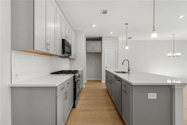 714 Smokey Quartz Way, Kennesaw, GA 30144 - kitchen featuring stainless steel appliances, gray cabinetry, a sink, and recessed lighting