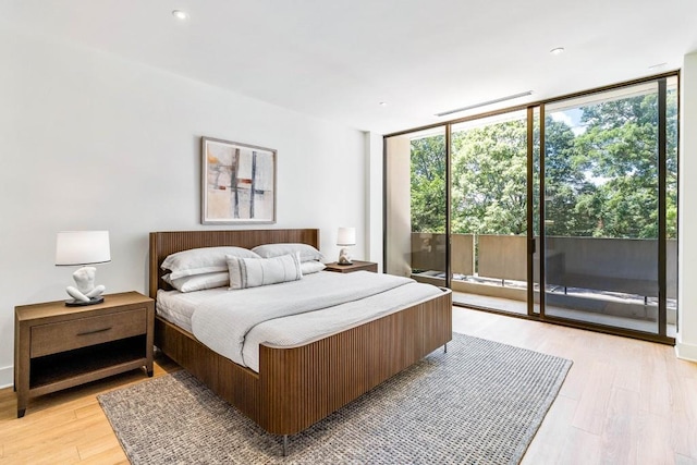 2575 Peachtree Rd NE Unit 6G, Atlanta, GA 30305 - bedroom with a wall of windows, access to exterior, multiple windows, light wood-style flooring, and recessed lighting