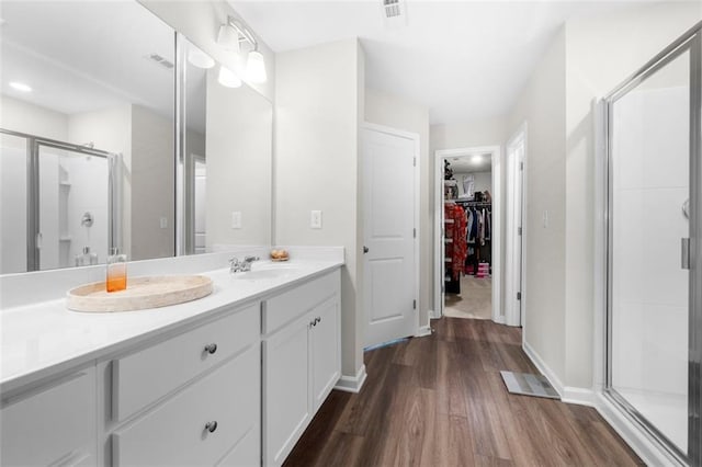 1025 Cherryfield Run, Marietta, GA 30008 - full bath featuring wood finished floors, a stall shower, vanity, a spacious closet, and baseboards