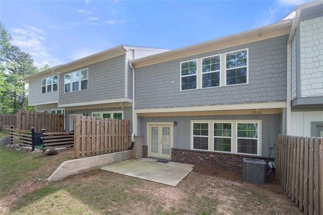 1025 Cherryfield Run, Marietta, GA 30008 - back of house featuring french doors, board and batten siding, cooling unit, a patio area, and brick siding