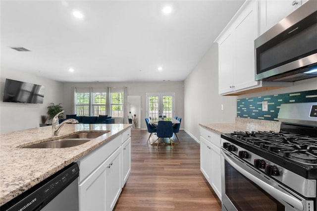 1025 Cherryfield Run, Marietta, GA 30008 - kitchen featuring appliances with stainless steel finishes, a sink, wood finished floors, recessed lighting, and white cabinets