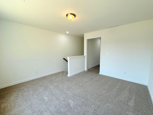 unfurnished room featuring visible vents, baseboards, and carpet
