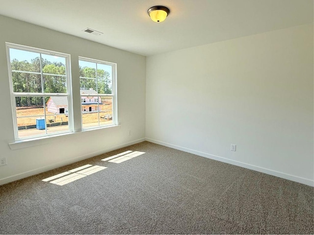 carpeted empty room with baseboards and visible vents