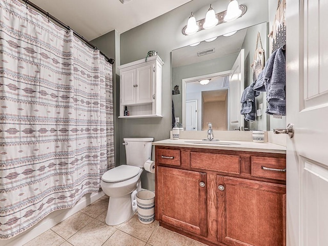 bathroom with vanity, tile patterned floors, and toilet