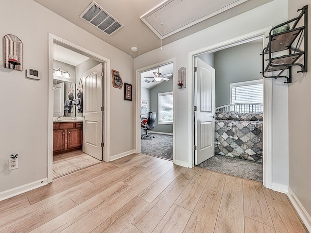 hall featuring lofted ceiling and light wood-type flooring