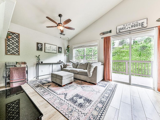 living room with hardwood / wood-style flooring, ceiling fan, and lofted ceiling